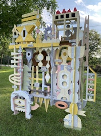 a large wooden structure in a grassy area